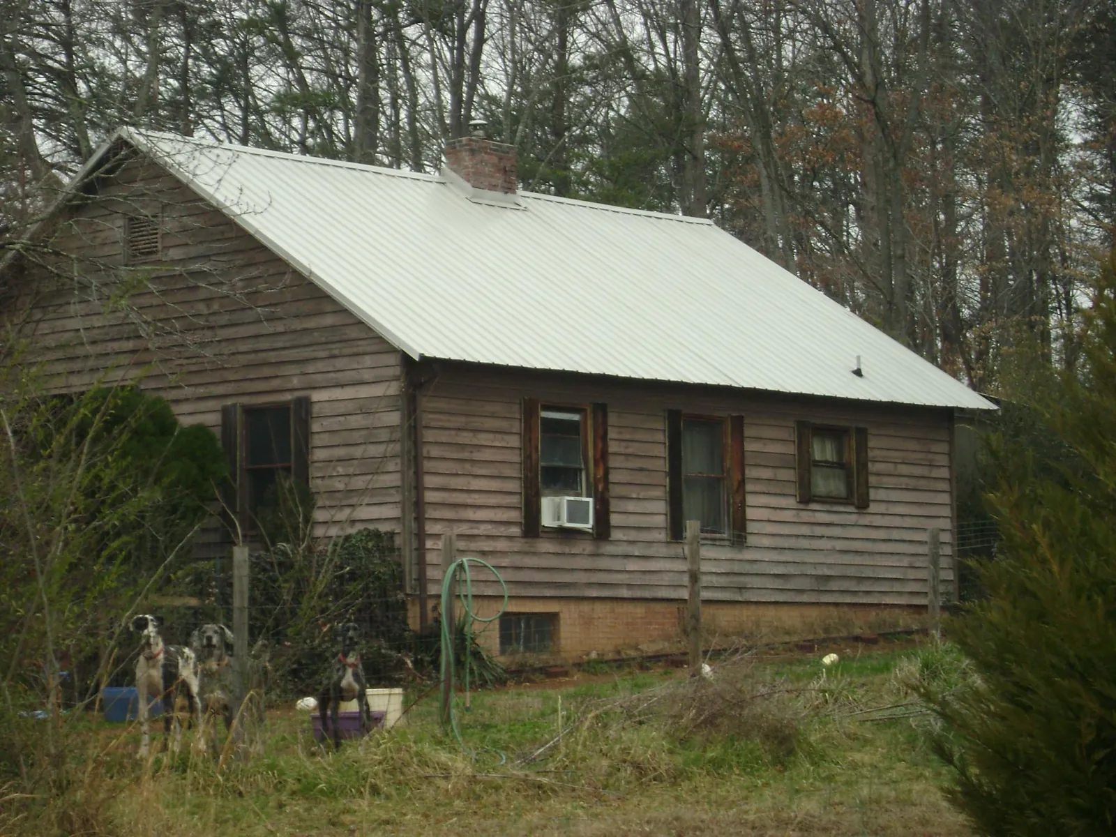 White metal roof on an old wood sided farmhouse, from a Asphalt Shingle Roof Repair job in Fort Leavenworth
